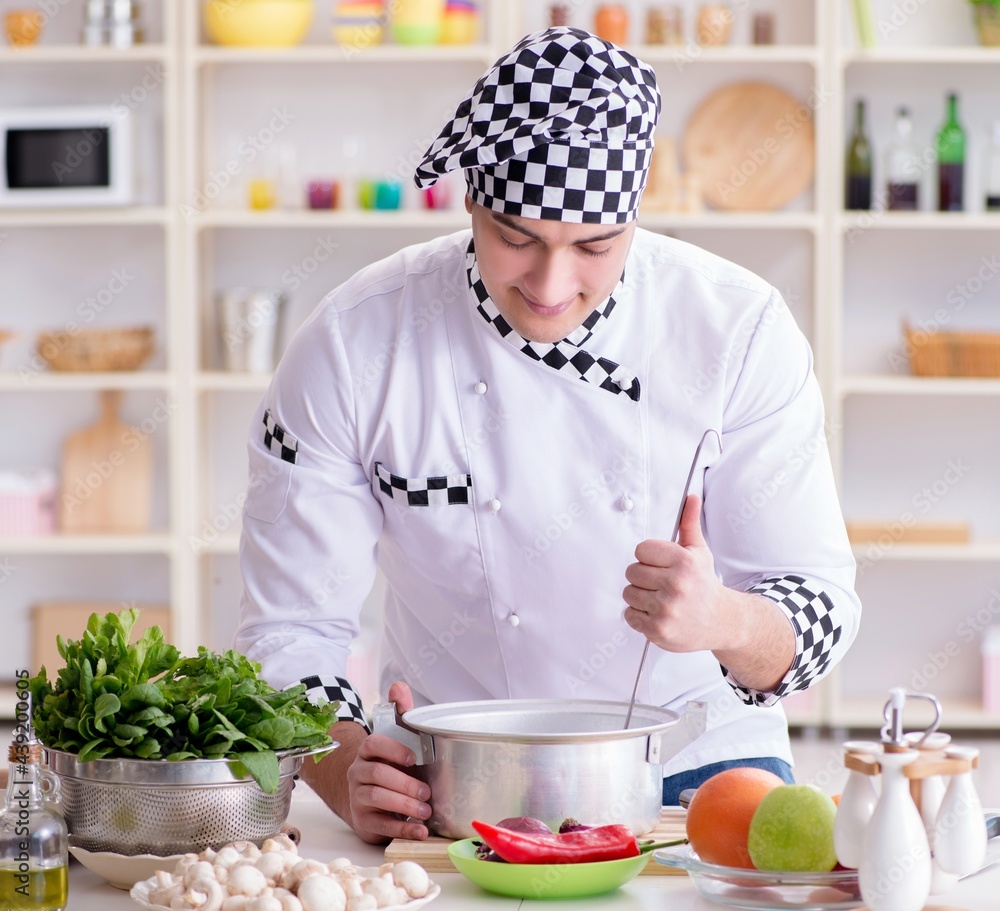 Young male cook working in the kitchen Young male cook working in the kitchen