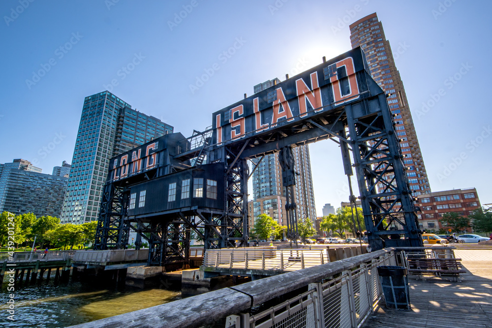 Long Island City, NY - USA- June 13, 2021: A view of Gantry Plaza State Park, with transfer bridges, support gantries, and piers. on the East River in the Hunters Point section of Long Island City.