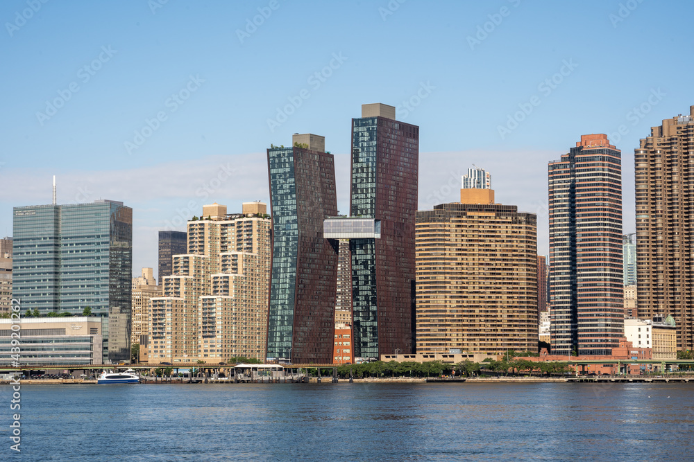 Long Island City, NY - USA - June 13, 2021: Landscape view of the east side of Manhattan. Featuring the American Copper Buildings.
