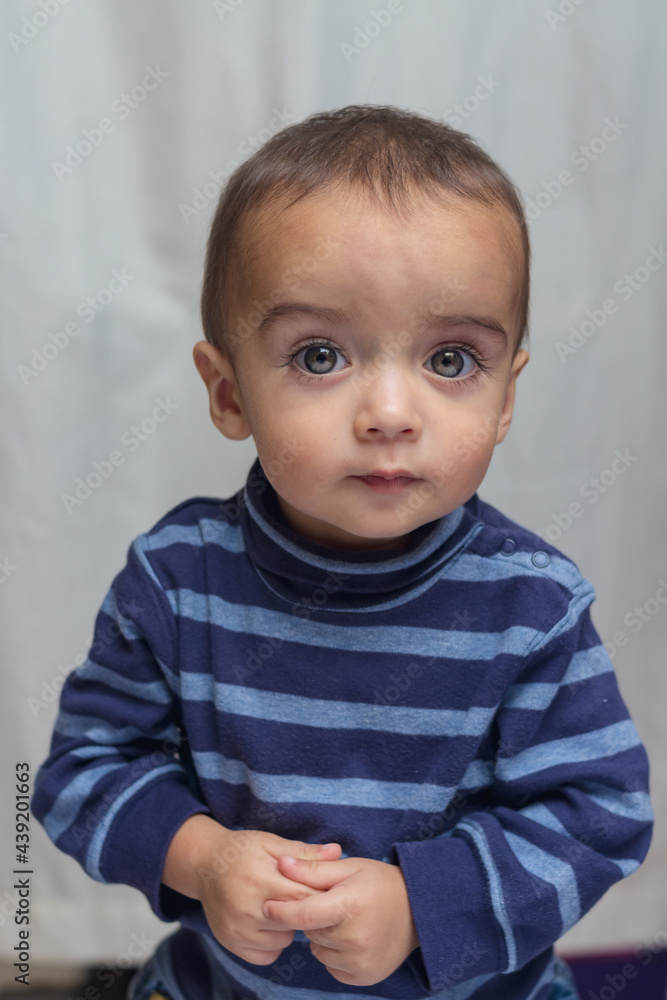 portrait of child expressing amazement in a tender way portrait of child expressing amazement in a tender way