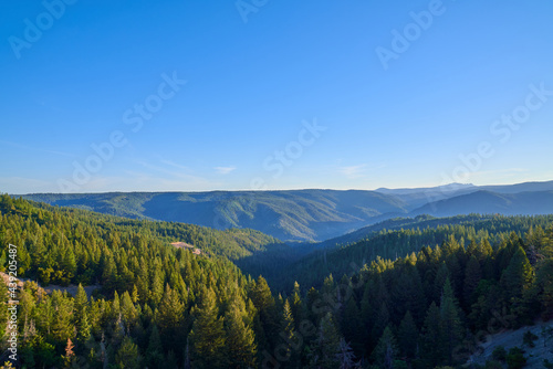Scenic View of Northern California mountains in the early morning with blue skies and fog 