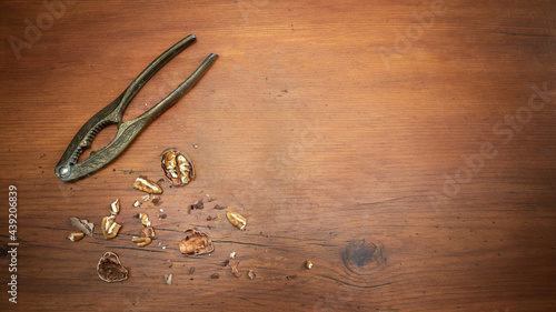 Vintage Nut Cracker with pecan nuts on a wood table photo