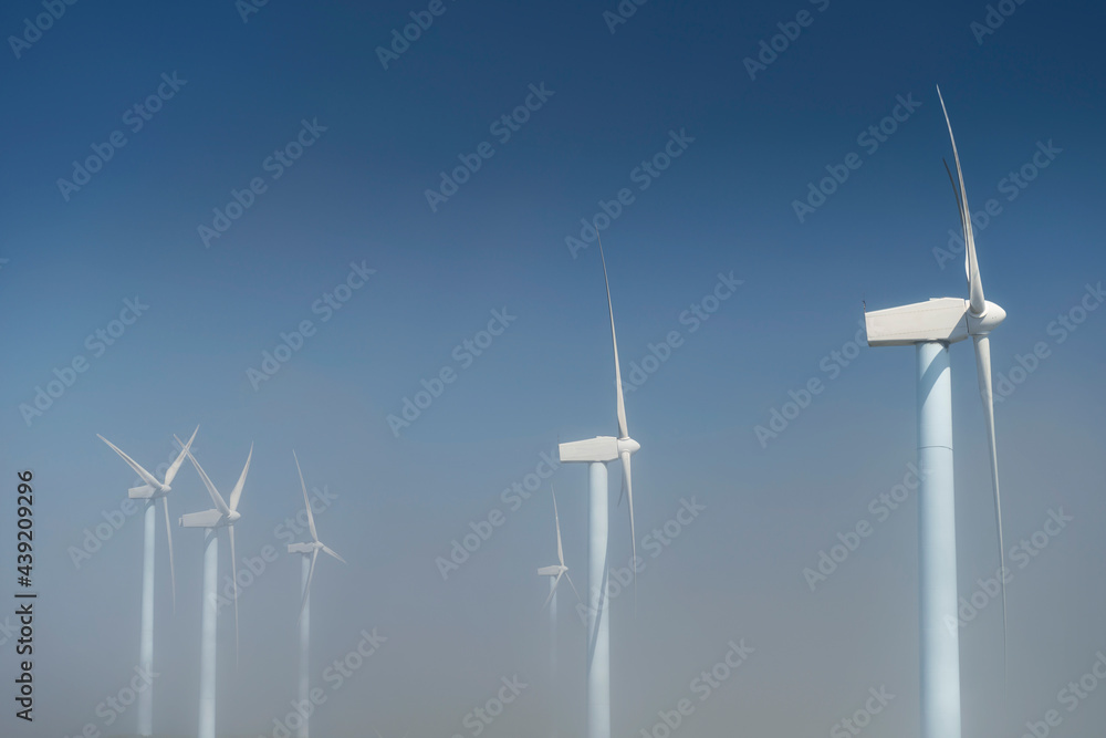 several wind turbines on a wind farm above the clouds several wind turbines on a wind farm above the clouds