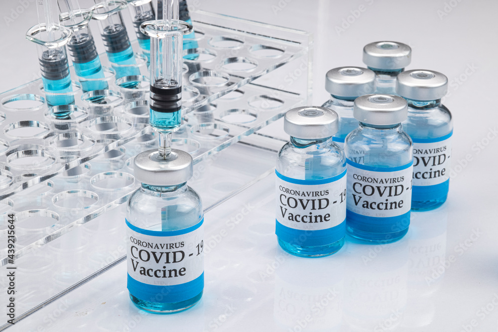 Glass vials labelled with COVID-19 . Glass vials labelled with COVID-19 .