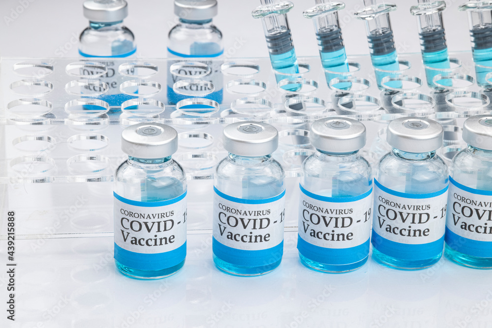 Glass vials labelled with COVID-19 . Glass vials labelled with COVID-19 .