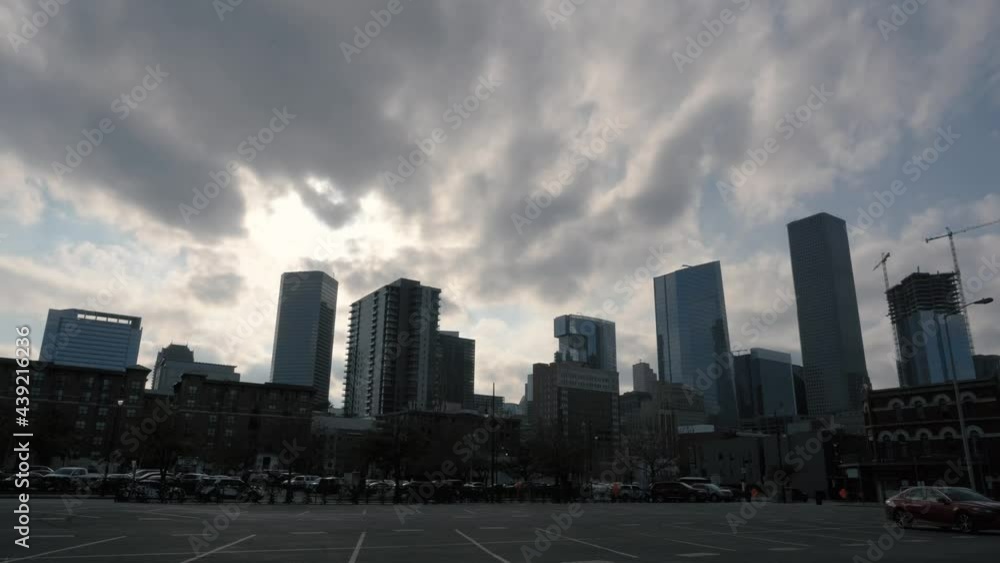 The sun sets behind clouds over the Houston, Texas skyline. The sun sets behind clouds over the Houston, Texas skyline.