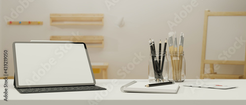 Digital tablet with mock-up screen and keyboard on study table in living room, 3D rendering