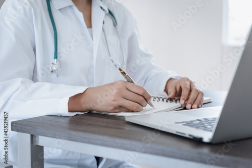 Female Physician Doctor Working at Her Desk in Examination Room  Close-Up Portrait of Medical Doctor Consulting and Diagnose Disease Patient at Clinic Hospital. Business Healthcare  Health Medicine