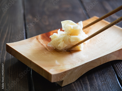 お寿司にかかせないガリ。木製の寿司下駄に乗せた、甘酢に漬けた生姜。 photo