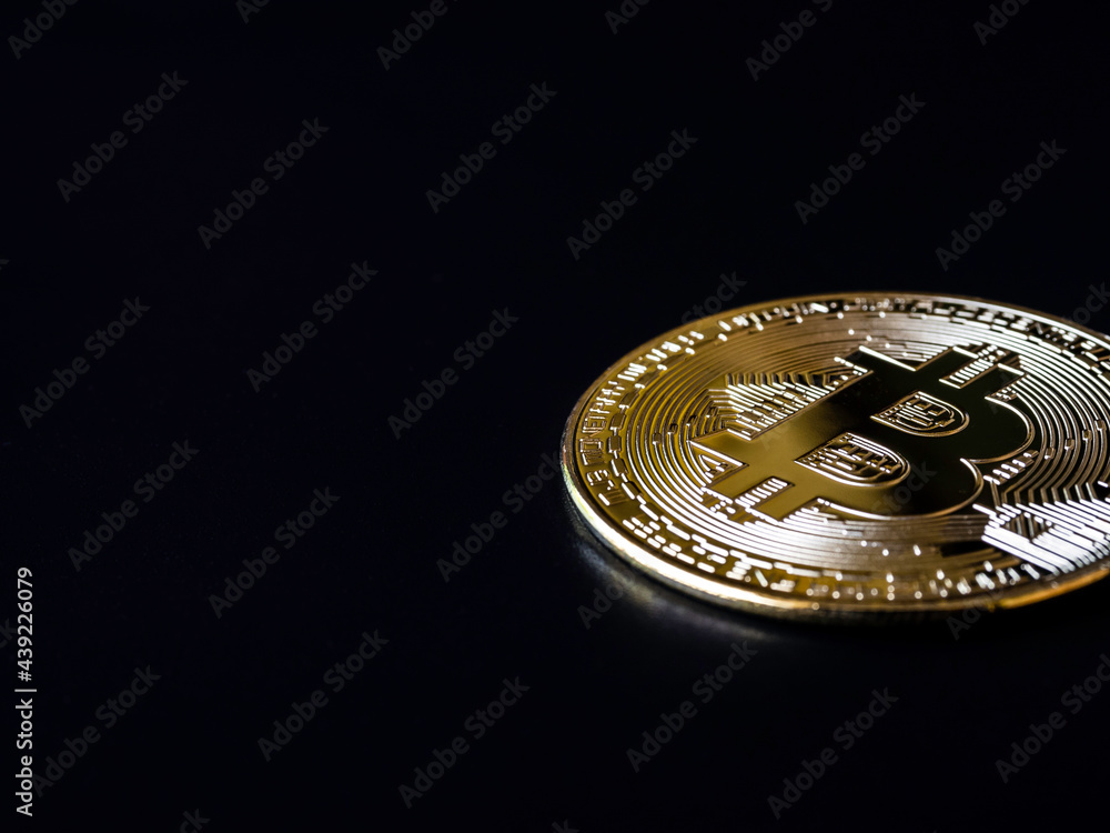 Bitcoin technology dark background. A golden bitcoin on black background with copy space, cryptocurrency investment concept. Digital future coin currency financial background.