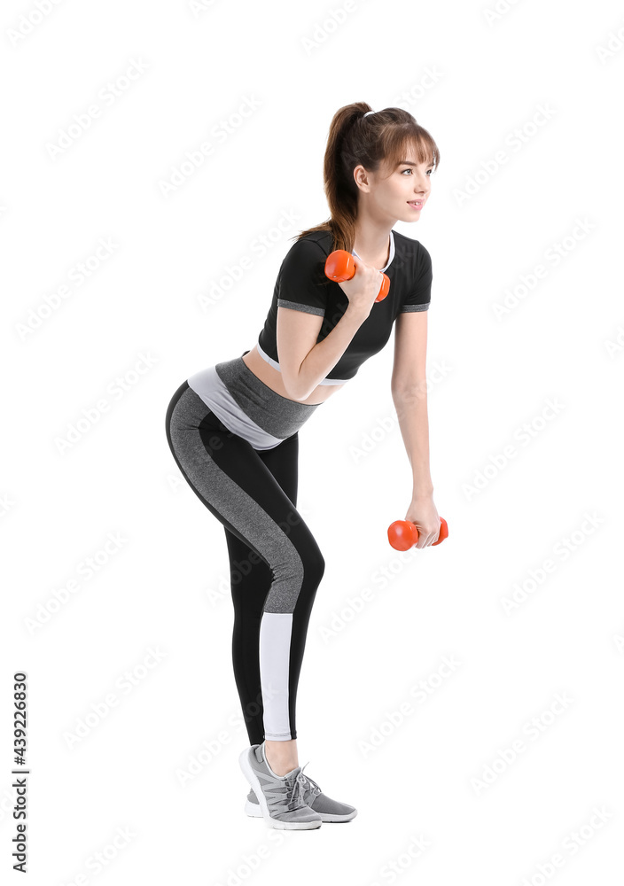 Sporty young woman training with dumbbells on white background Sporty young woman training with dumbbells on white background