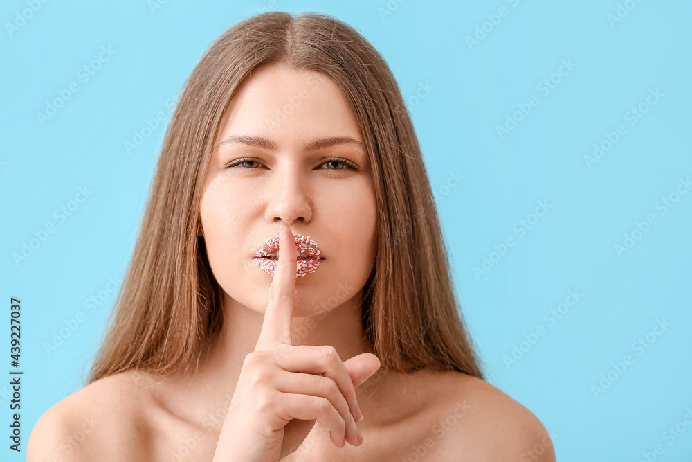 Beautiful young woman with creative makeup showing silence gesture on color background Beautiful young woman with creative makeup showing silence gesture on color background