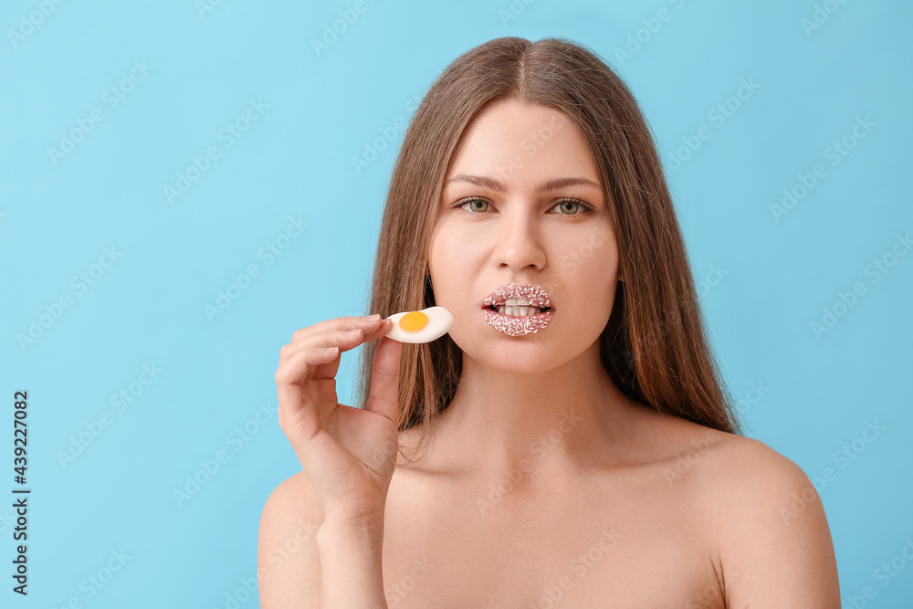 Beautiful young woman with creative makeup and sweet candy on color background Beautiful young woman with creative makeup and sweet candy on color background