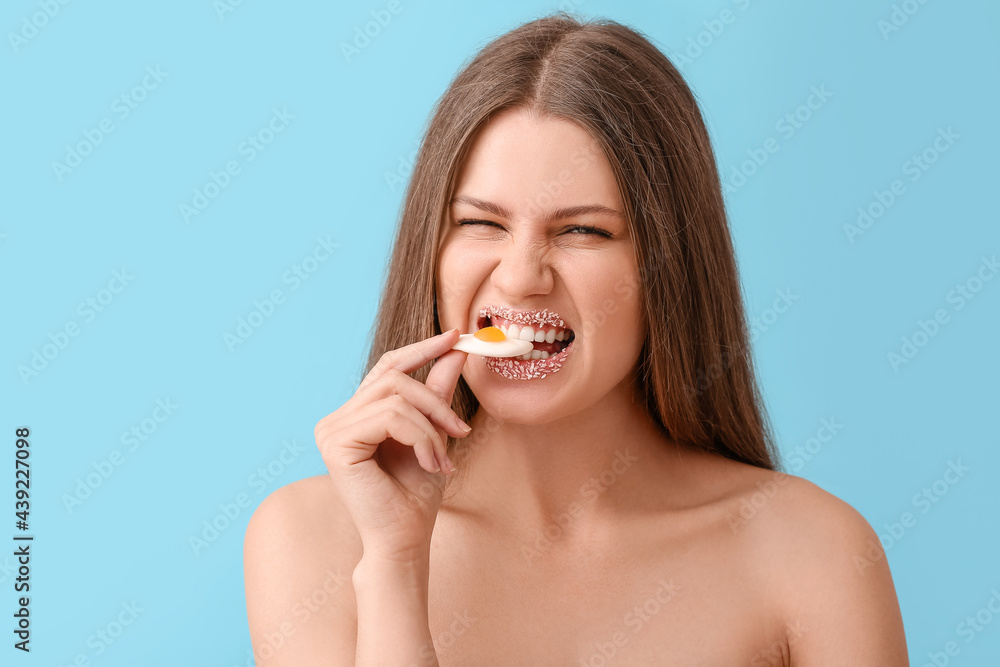 Beautiful young woman with creative makeup and sweet candy on color background Beautiful young woman with creative makeup and sweet candy on color background