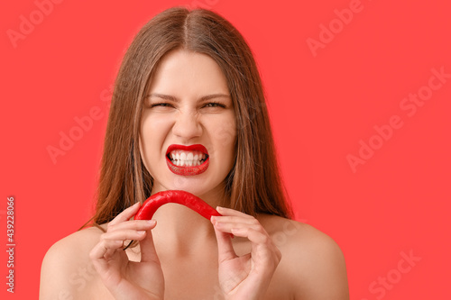 Sexy young woman with chili...