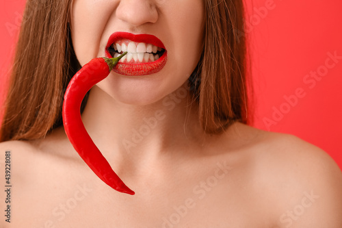 Sexy young woman with chili...