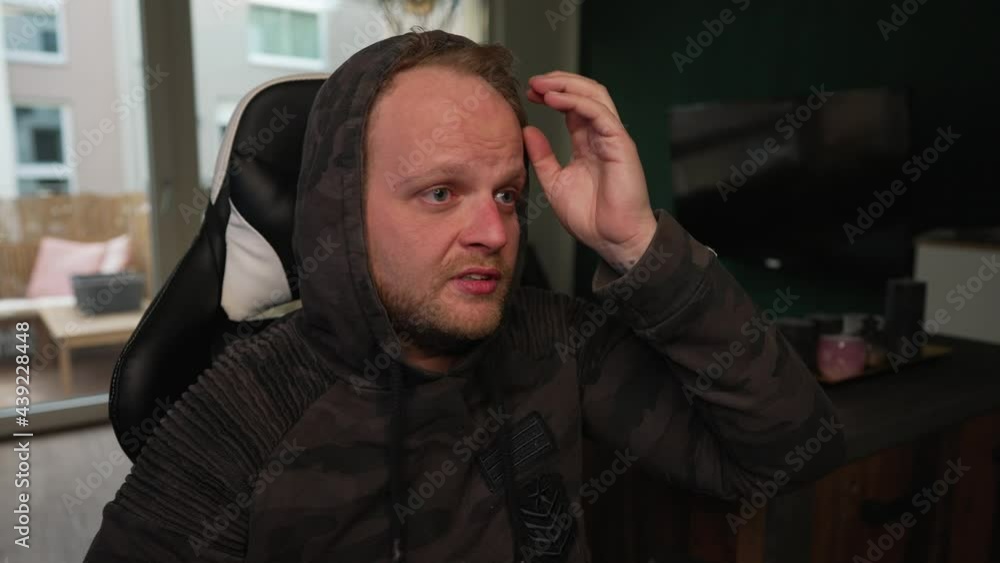 STREAMING - Man fixes hair, talking to camera, content creator, medium shot STREAMING - Man fixes hair, talking to camera, content creator, medium shot