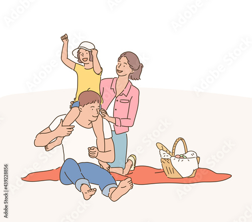 Dad, mom and child are having a good time on a picnic. hand drawn style vector design illustrations. 
