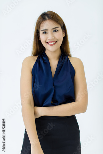 Attractive cutout portrait of a beautiful, healthy young Caucasian, Asian woman on blue casual tank top and black slacks standing with hand holding, smiling, and good looking eye expression of happy