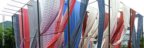 Colourful pattern fabric hanging on traditional outdoor dryer at rural Fujian, China