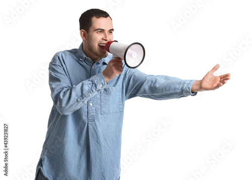 Handsome man shouting into megaphone on white background