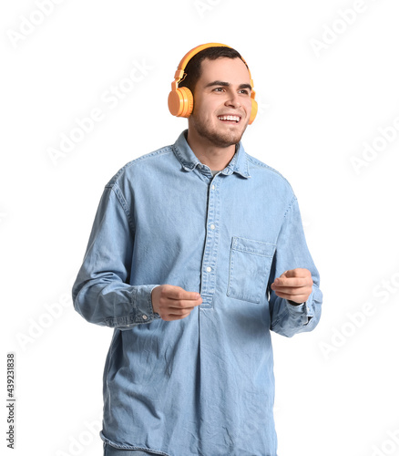 Handsome man listening to m...
