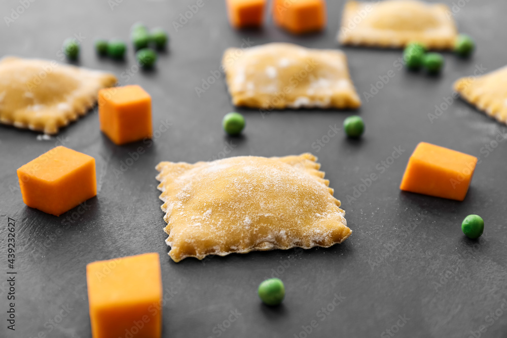 Raw ravioli on dark background