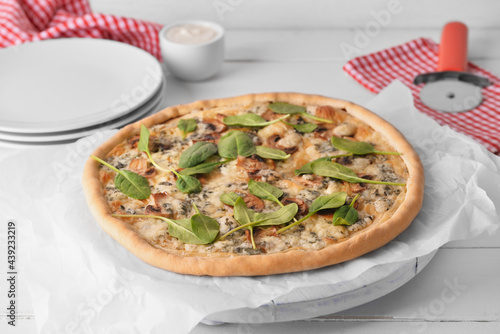 Delicious vegetarian pizza on light wooden background