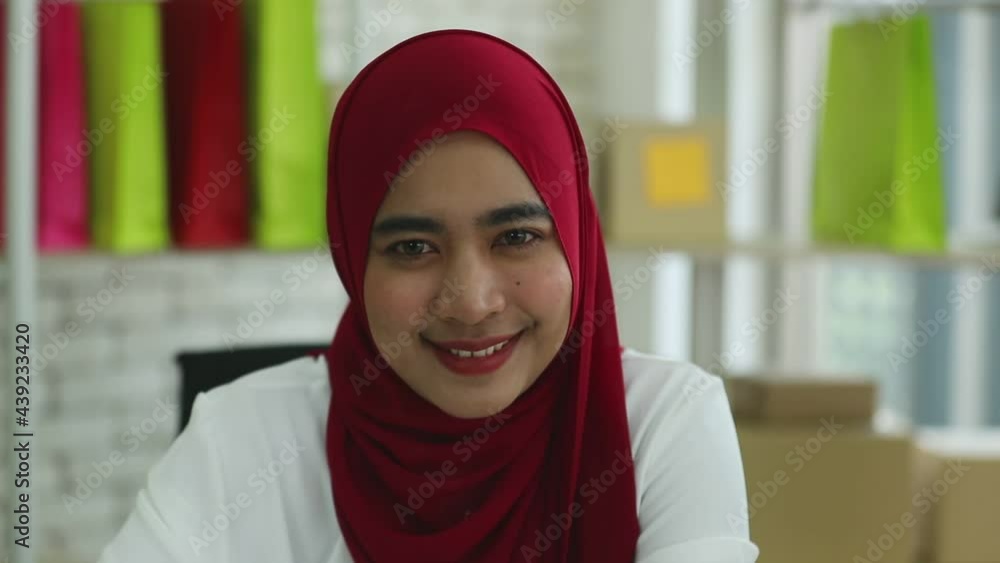 Camera zoom in the face with slow motion: a portrait of smiling Asian muslim young women with blurly background Camera zoom in the face with slow motion: a portrait of smiling Asian muslim young women with blurly background