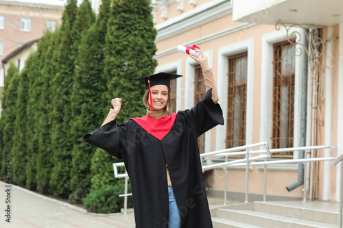 Happy female student in bac...