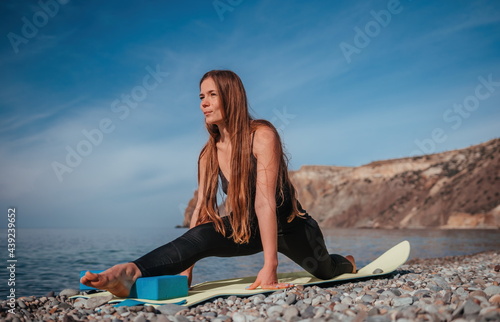 Young woman with long hair, fitness instructor in black Sportswe photo