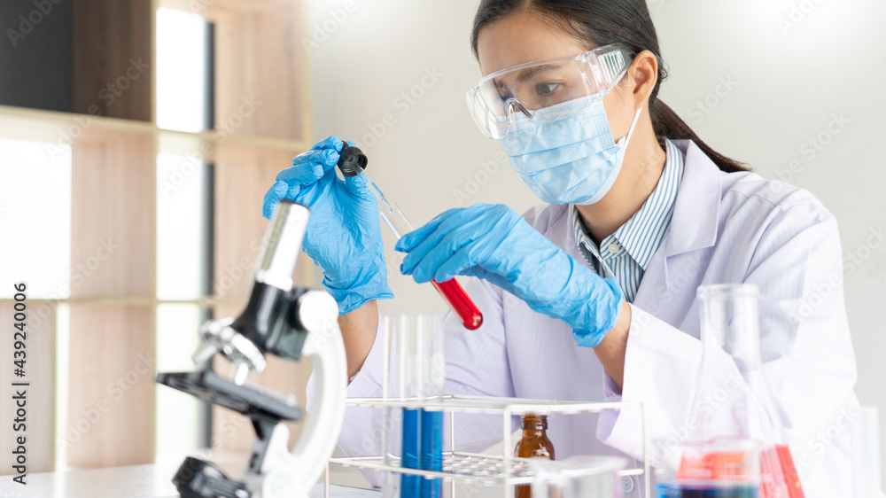 scientists researching in laboratory in white lab coat, gloves analysing, looking at test tubes sample, biotechnology concept scientists researching in laboratory in white lab coat, gloves analysing, looking at test tubes sample, biotechnology concept