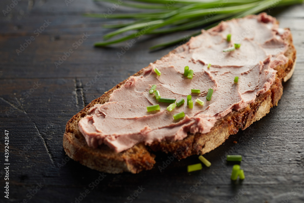 Open sandwich with liver pate and green onion