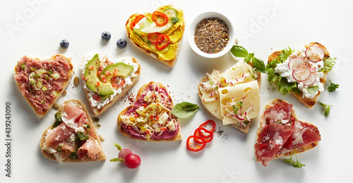Assorted delicious toasts on white table