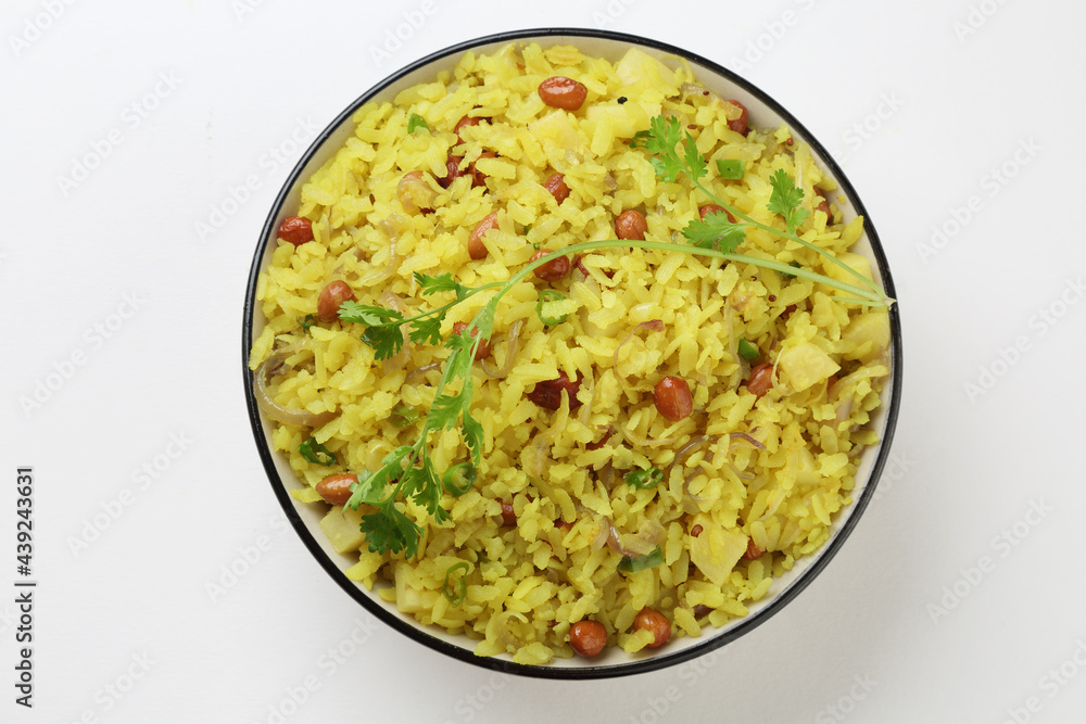 Indian Breakfast Dish Poha Also Know as Pohe or Aalu poha made up of Beaten Rice or Flattened Rice. The rice flakes are lightly fried in oil with mustard, turmeric, onion, curry leaves Indian Breakfast Dish Poha Also Know as Pohe or Aalu poha made up of Beaten Rice or Flattened Rice. The rice flakes are lightly fried in oil with mustard, turmeric, onion, curry leaves