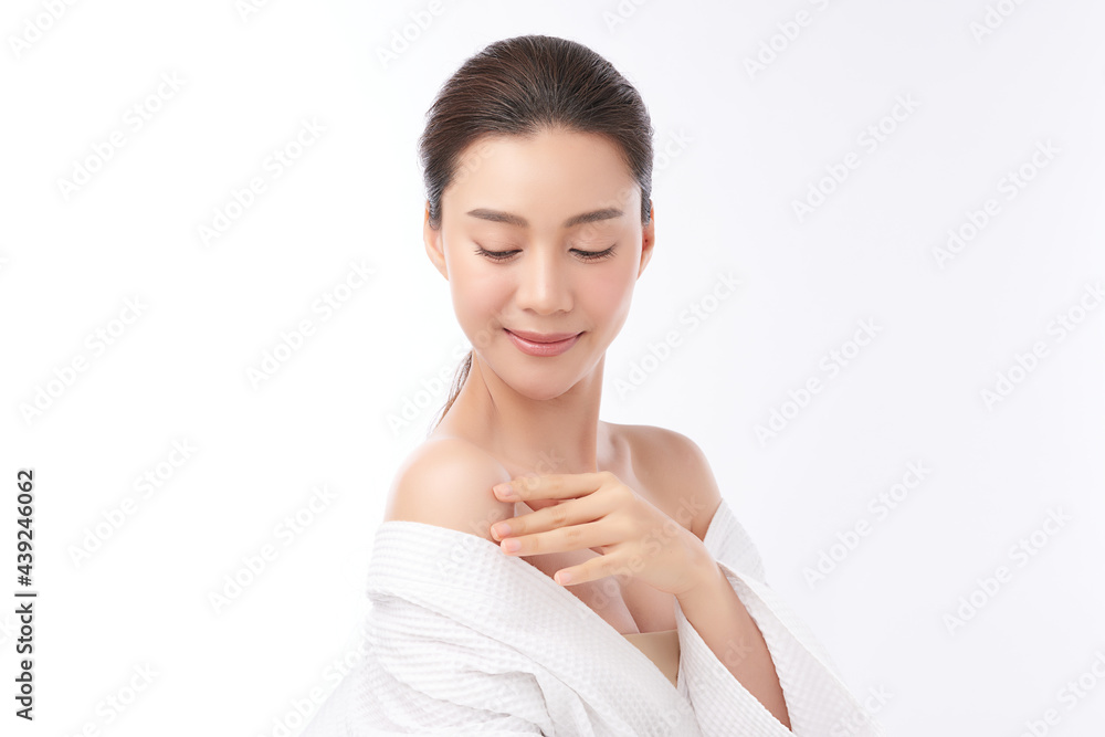 Beautiful young Asian woman wearing bathrobe on white background, Face care, Facial treatment, Cosmetology, beauty and spa Concept. Beautiful young Asian woman wearing bathrobe on white background, Face care, Facial treatment, Cosmetology, beauty and spa Concept.