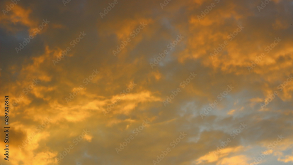 Cloudy sky at sunset on a spring evening as a background.