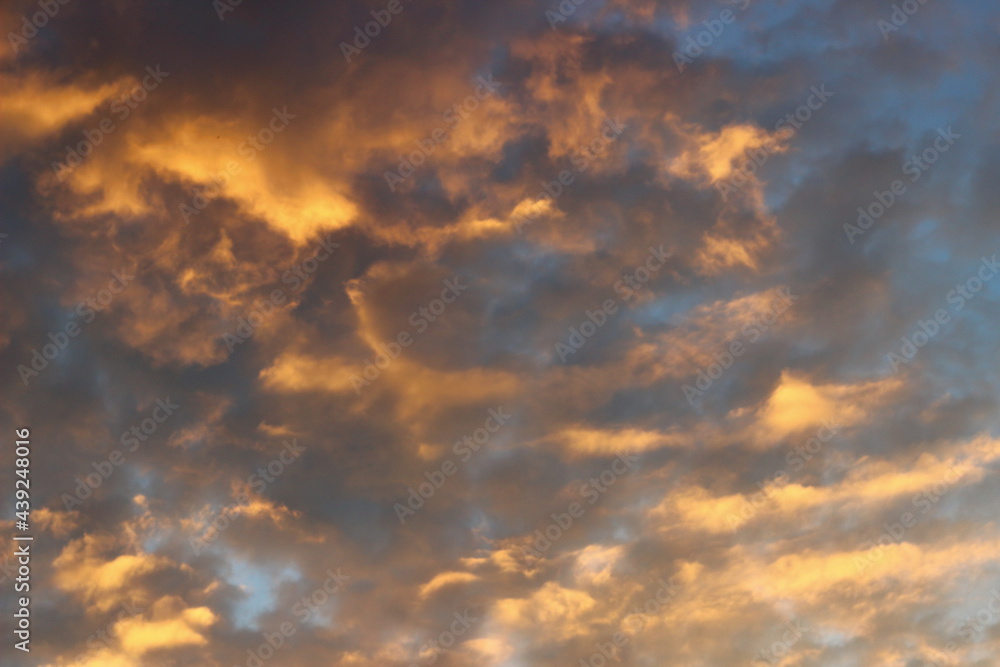 Cloudy sky at sunset on a spring evening as a background.