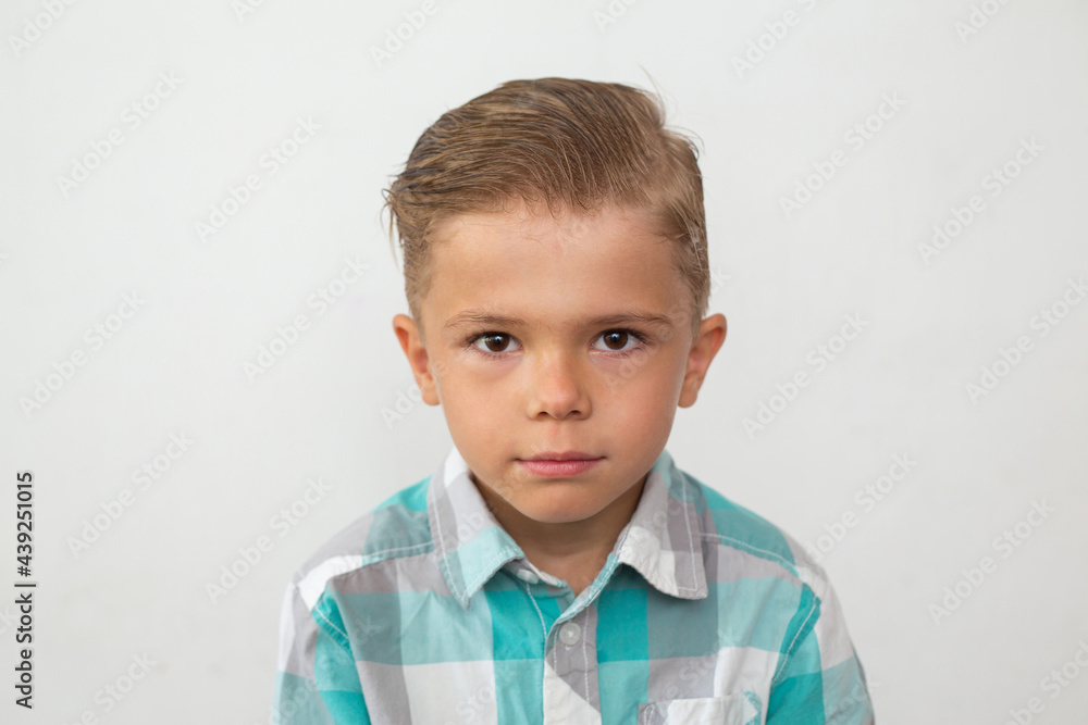 portrait of a boy in a shirt over white portrait of a boy in a shirt over white