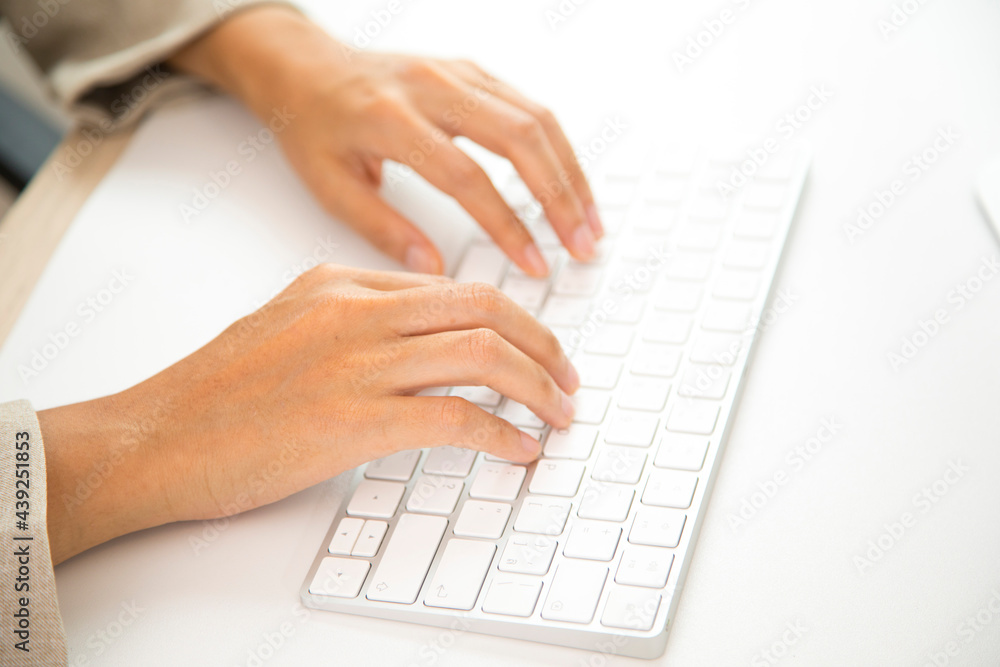 Manager typing on computer keyboard at wooden desk. Close up woman hands on keyboard. Manager typing on computer keyboard at wooden desk. Close up woman hands on keyboard.
