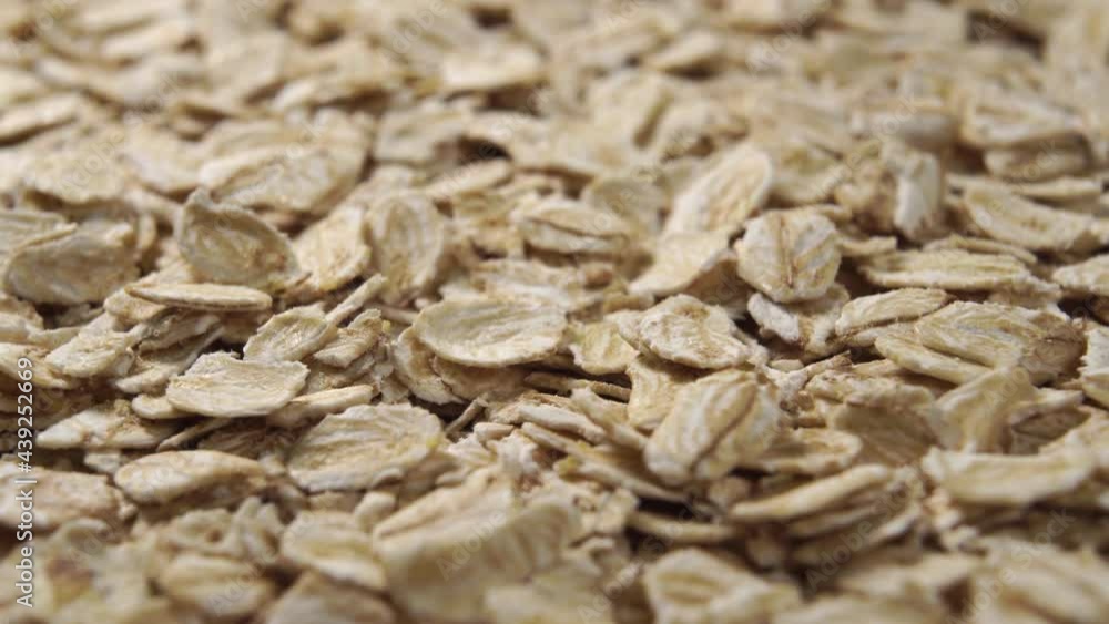 A pile of raw coarse cereal oat flakes. Macro shot. Rotation A pile of raw coarse cereal oat flakes. Macro shot. Rotation