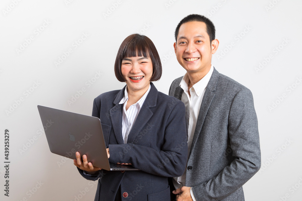 Asian businesswoman and businessman holding computer standing on white background. Asian businesswoman and businessman holding computer standing on white background.