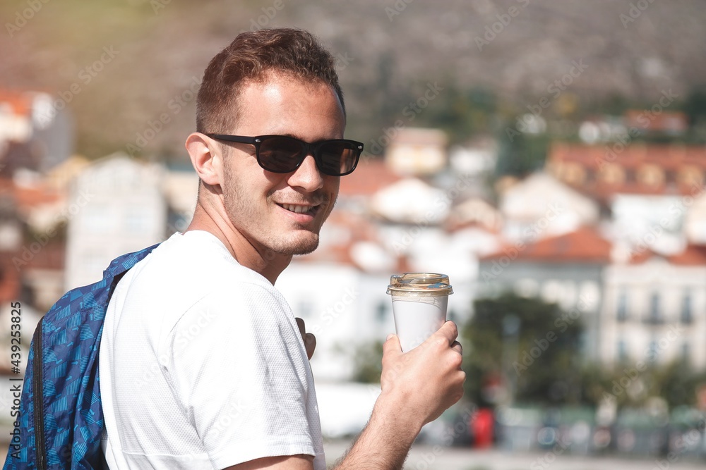 man with bag and coffee to go sightseeing man with bag and coffee to go sightseeing