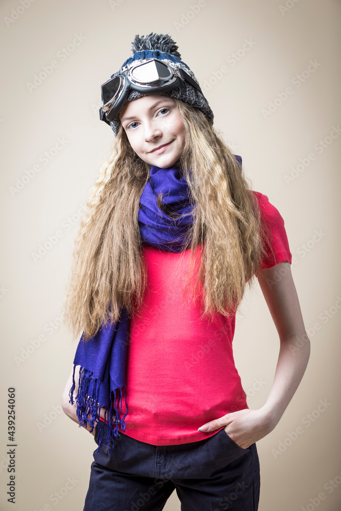 Calm and Smiling Caucasian Teenager in Pink Tshirt and Aviator Glasses Posing Over Beige Background. Vertical Image Composition Calm and Smiling Caucasian Teenager in Pink Tshirt and Aviator Glasses Posing Over Beige Background. Vertical Image Composition