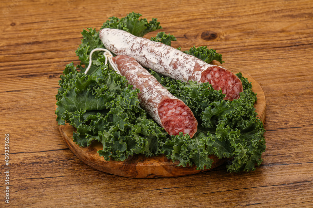 Spanish Fuet sausage with salad leaves