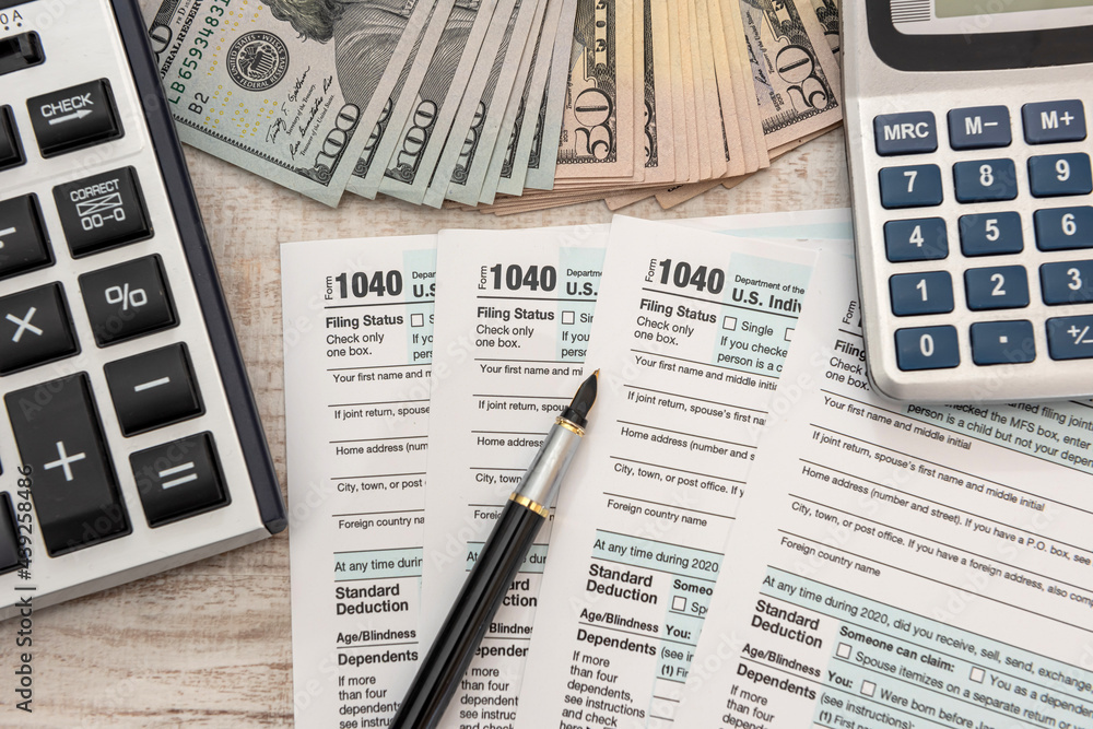 1040 individual form, with us money. Tax time concept 1040 individual form, with us money. Tax time concept