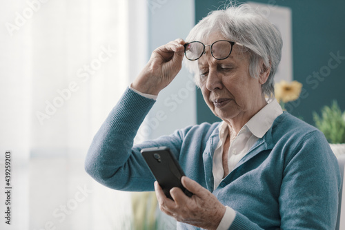 Senior woman having vision problems photo