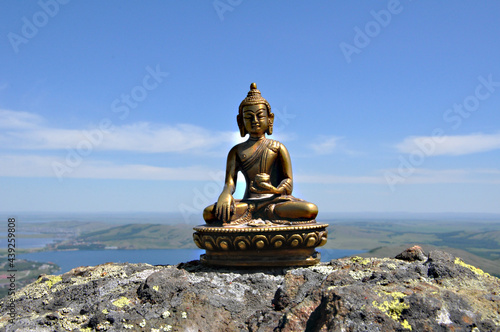 Canvas Print Statuette of Buddha against the sky