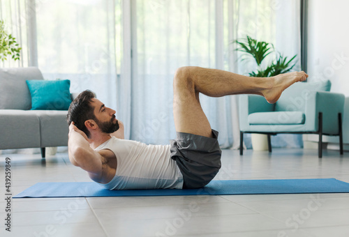 Man exercising abs at home