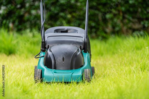 lawn mower on green grass at home